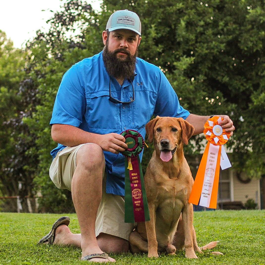 Ian and finished retriever with ribbons